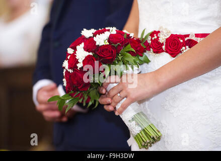 Sposa e lo sposo nella chiesa tenendo le mani Foto Stock