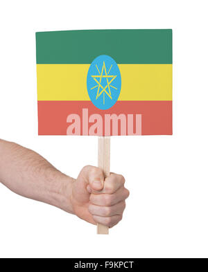 Mano azienda piccola scheda, isolato su bianco - la bandiera di Etiopia Foto Stock