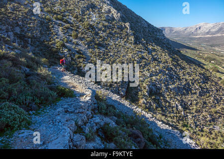 Femmina con walker red zaino sulla strada italiana, Kalymnos Grecia Foto Stock