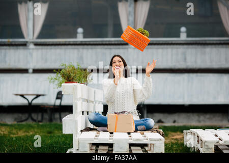 Giovane ragazza getta un regalo Foto Stock