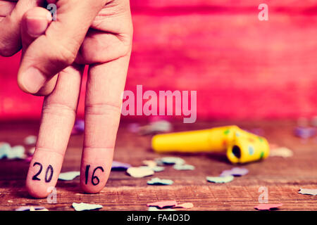 Primo piano della mano di un giovane uomo che fa l'azione di camminare con le sue dita con il numero 2016, come il nuovo anno, scritto Foto Stock