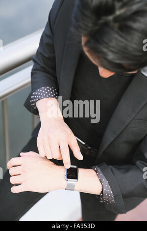 Imprenditore giapponese con smart indossabile watch Foto Stock