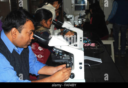 Studenti che lavorano nel laboratorio di biologia con microscopio Foto Stock