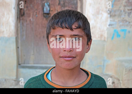 Un ragazzo yemenita di Thuja, città fortificata a nord-ovest di Sana'a, cisterna, villaggio, porta di legno, Repubblica dello Yemen, vita quotidiana Foto Stock