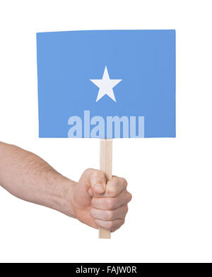 Mano azienda piccola scheda, isolato su bianco - la bandiera della Somalia Foto Stock