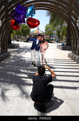 Foto verticale del giovane adulto giovane fotografato azienda ogni altra molto strettamente con palloncini. Foto Stock