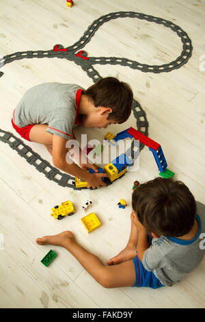 Il Toddler ragazzi giocare con toy train set. Foto Stock