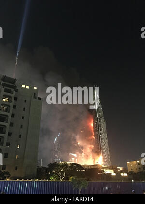 Dubai, Emirati Arabi Uniti. 31 Dic, 2015. Foto scattata da un dispositivo mobile mostra Indirizzo centro di Dubai hotel sul fuoco a Dubai, Emirati Arabi Uniti, a Dic. 31, 2015. Incendio scoppiato il giovedì in un lussuoso hotel di Dubai dove la gente si riuniva vicino a guardare il nuovo anno di spettacolo di fuochi d'artificio. Credito: Liu Yang/Xinhua/Alamy Live News Foto Stock