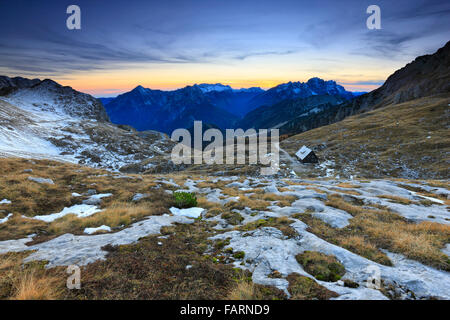 Tramonti sulle montagne paesaggio. Mangart, sulle Alpi Giulie Slovenia e Italia. Foto Stock