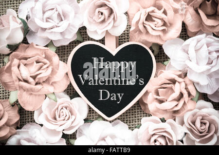 Buon San Valentino tag di legno con rose su sfondo a sacco in stile vintage. Foto Stock