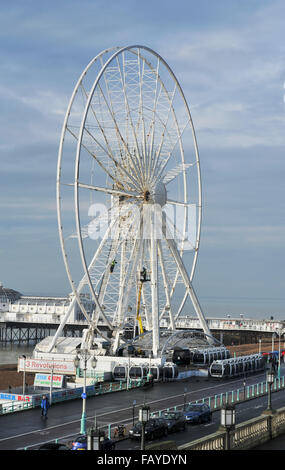 Brighton Regno Unito 6 Gennaio 2016 - operai di scala del Brighton ruota sul lungomare per effettuare la manutenzione invernale pronto a lavorare per la nuova stagione . La ruota sorge a 45 metri di diametro e offre vedute del litorale circostante architettura e i punti di riferimento Credito: Simon Dack/Alamy Live News Foto Stock