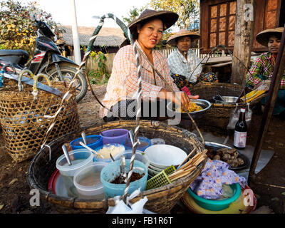 Un venditore ambulante di vendita alimentari per gli abitanti dei villaggi locali. Foto Stock