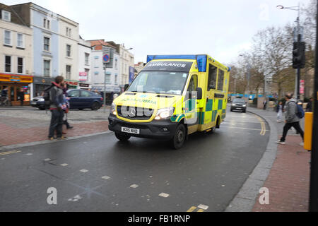 Giallo British ambulanza su una luce blu eseguire nel centro di Bristol. 6 Dicembre 2015 Foto Stock