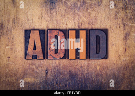 La parola "ADHD' scritta in presenza di sporco vintage tipo di stampa in rilievo su di un legno invecchiato sfondo. Foto Stock