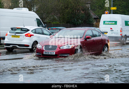 Aylesford, Maidstone Kent REGNO UNITO 11 Gennaio, 2016. Dopo una forte pioggia durante la notte gli spruzzi di traffico attraverso le profonde acqua di inondazione sulla A20, Jaguar XF Credito: Matthew Richardson/Alamy Live News Foto Stock