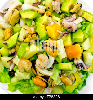 Insalata di gamberetti, polipetti, cozze e calamari con avocado, lattuga, ananas isolati su sfondo bianco top Foto Stock