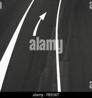 Asfalto stradale astratta, due linee bianche e freccia destra segno Foto Stock
