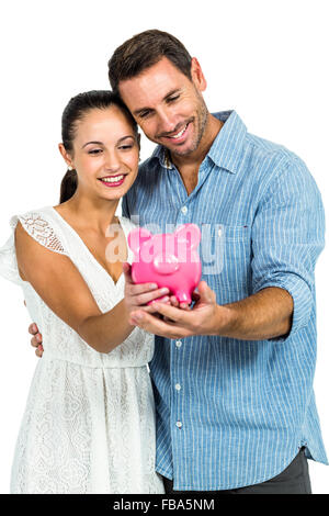 Coppia giovane azienda piggybank Foto Stock