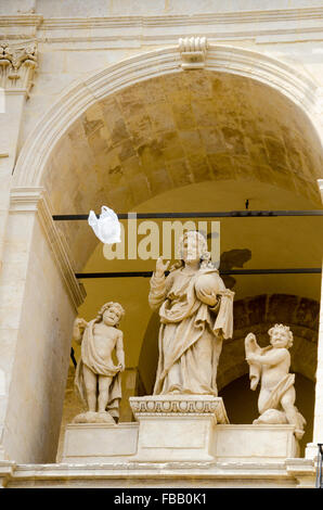 Vento che soffia un scartato il sacchetto in plastica nella parte anteriore della chiesa di San Paolo a Palazzolo, Italia. Foto Stock