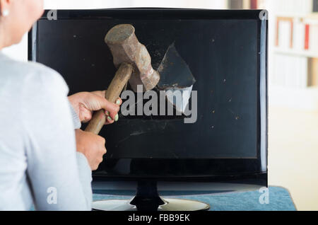 Femmina martello holding smashing nella schermata del computer. Foto Stock