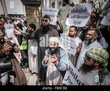 Immagini di FILE: Londra, Regno Unito. 12 Luglio, 2013. File di immagini da 12-07-2013: Mohammed Reza Haque (centro, indossando occhiali da sole), 35, noto come "Giant ' sospettate di essere il secondo britannico estremista islamico pensato per essere tra un team di carnefici che hanno ucciso cinque "spie" in Siria nei primi mesi di quest'anno. Vedere qui nel 2013 al di fuori del Regent's Park moschea durante una protesta islamista organizzato da chierico radicale Anjem Choudary (destra) Credito: Guy Corbishley/Alamy Live News Foto Stock