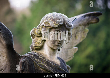 Angelo su una tomba in un cimitero su un gelido inverno di mattina Foto Stock