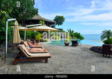 Gli ospiti si rilassano presso la piscina a sfioro del Pacific Resort sulla piccola isola tropicale di Aitutaki, Isole Cook, Sud Pacifico Foto Stock