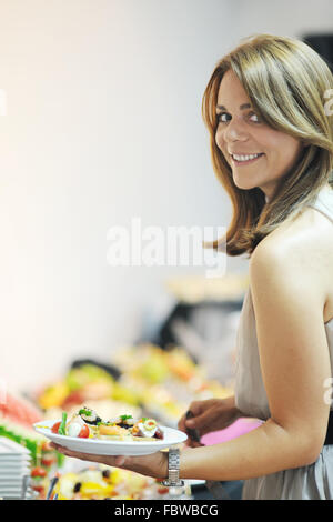 Womanl sceglie gustosi pasti a buffet presso l'hotel Foto Stock