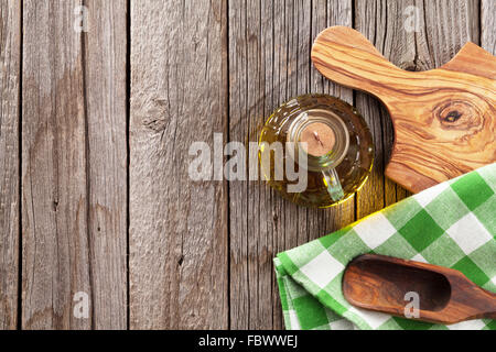 Olio di oliva Bottiglia e utensili sul tavolo di legno. Vista da sopra con lo spazio di copia Foto Stock