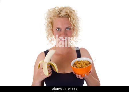 Giovane donna con una banana Foto Stock