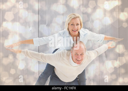Immagine composita di felice coppia matura divertendosi Foto Stock