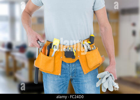 Immagine composita del tecnico tenendo i guanti e un martello Foto Stock