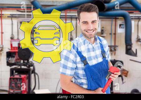 Immagine composita di fiducioso giovane maschio repairman holding Monkey Wrench Foto Stock