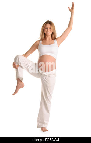 Donna incinta permanente e la pratica dello yoga Foto Stock