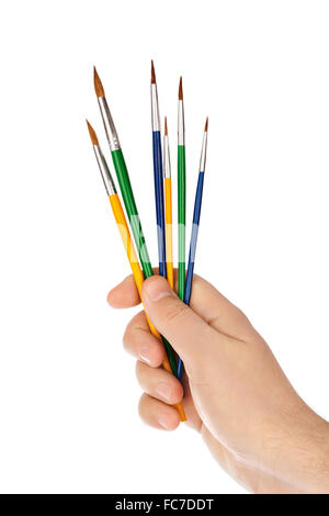 Mano con pennelli multicolore Foto Stock