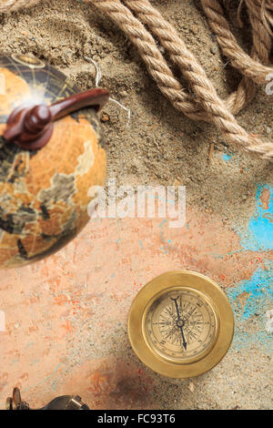 Set di strumenti nautici, distesi sulla sabbia e mappa vecchia. concetto avventura Foto Stock