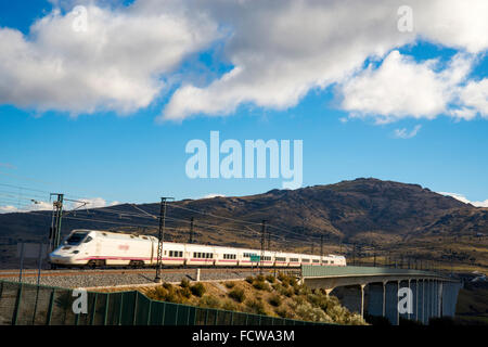 Madrid-Valladolid AVE treno ad alta velocità che viaggiano lungo la Arroyo del valle viadotto. Soto del Real, provincia di Madrid, Spagna. Foto Stock