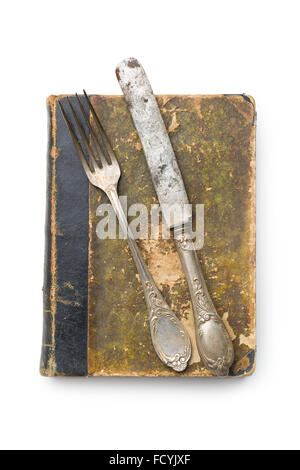Libro vintage e posate su sfondo bianco Foto Stock