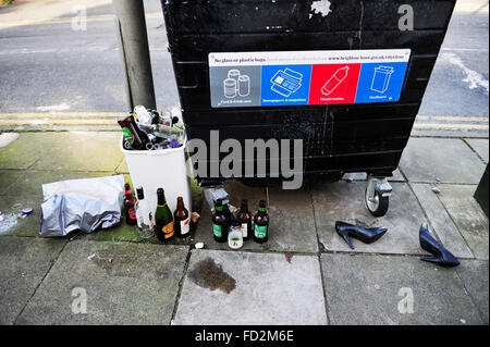 I resti di una festa selvaggia di bottiglie di bevande e le scarpe per essere gettato in street BRIGHTON REGNO UNITO Foto Stock