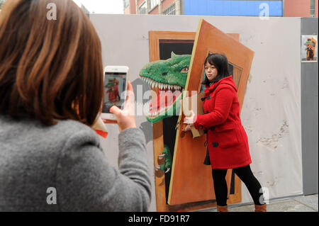 Chongqing Cina. 29 gen, 2016. I cittadini di scattare foto con la tecnica del trompe-l'oeil a Sanxia piazza di Chongqing, a sud-ovest della Cina, 29 gennaio, 2016. Trompe-l'oeil è una tecnica che utilizza immagini realistiche per creare l'illusione ottica che oggetti rappresentati esistono in tre dimensioni. © Tang Yi/Xinhua/Alamy Live News Foto Stock