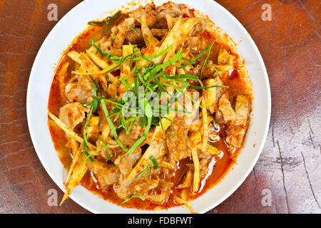 Mescolare la carne di maiale fritto ventre rosso con pasta di curry e germogli di bambù Foto Stock
