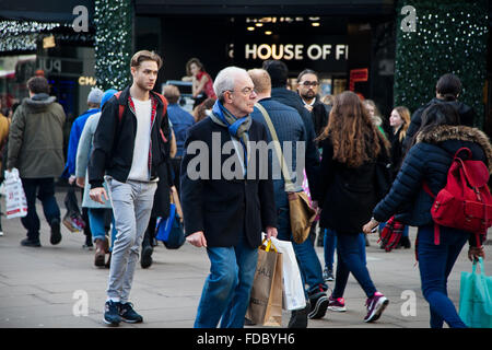 Christmas Shopper con borse per lo shopping in Oxford Street nel West End di Londra. Foto Stock