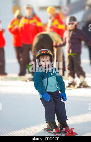 Il toddler boy Sciare in montagna invernale Foto Stock