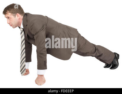 Imprenditore facendo push-up su a suon di pugni Foto Stock