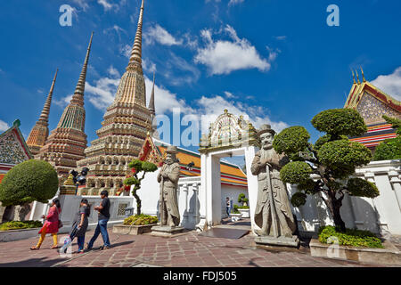 Persone che camminano presso il Phra Maha Chedi si Rajakarn, le grandi Pagode di quattro re nel tempio di Wat Pho. Bangkok, Tailandia. Foto Stock