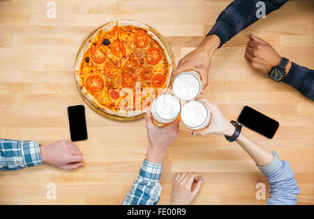 Vista dall'alto del gruppo di amici di mangiare pizza e bere birra Foto Stock