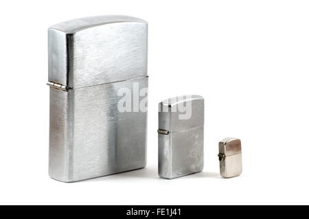 Tre differenti dimensioni di accendini metallico con tappo chiuso su bianco Foto Stock