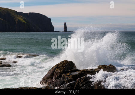 Atlantic di onde che si infrangono sulle rocce Shanabhait Tràigh, la spiaggia a Sandwood Bay, con il promontorio di Rubh' un Bhuachaille un Foto Stock