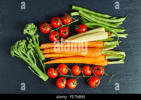 Ortaggi freschi su una lavagna, cibo organico, laici piatta Foto Stock