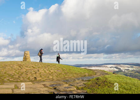 Walkers presso il punto di innesco sulla sommità del Mam Tor su un luminoso giorno d'inverno. Foto Stock